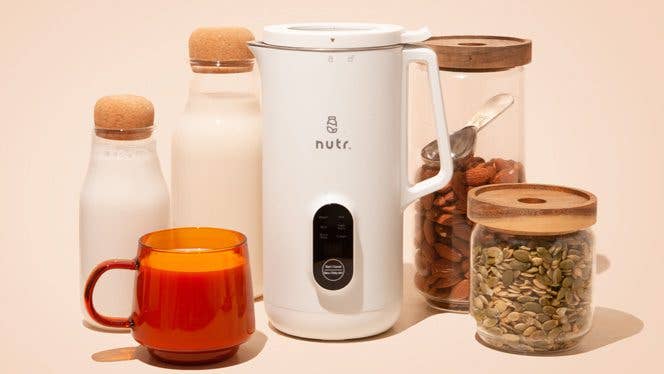 nutr machine Nutr machine next to glass jars of nut milk and jars of whole nuts